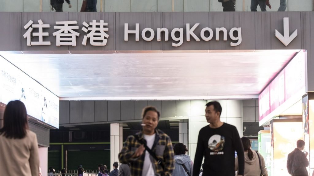 A sign directing travelers towards Hong Kong near the Luohu border crossing in Shenzhen, China, on Sunday, Jan. 14, 2024. Hong Kong saw about 2.9 million arrivals from mainland Chinese visitors in December through all points of entry including airports, down about 43% from 2018. Source: Bloomberg