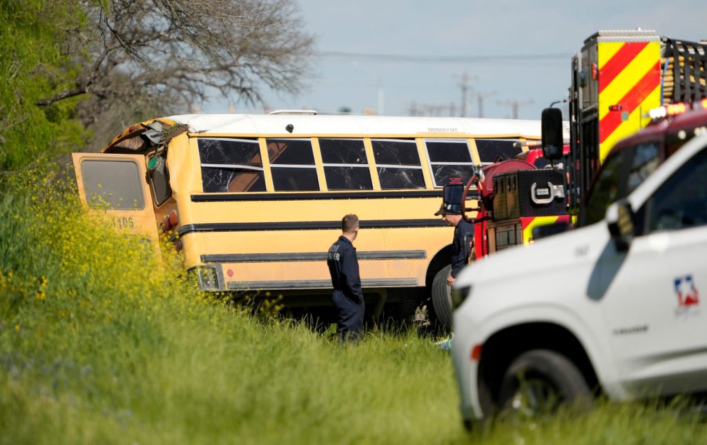 Officials look at a school bus that was carrying Tom Green Elementary pre-K students when it crashed in Austin, Texas, U.S., March 22, 2024.  Jay Janner/American-Statesman/USA TODAY NETWORK. NO RESALES. NO ARCHIVES