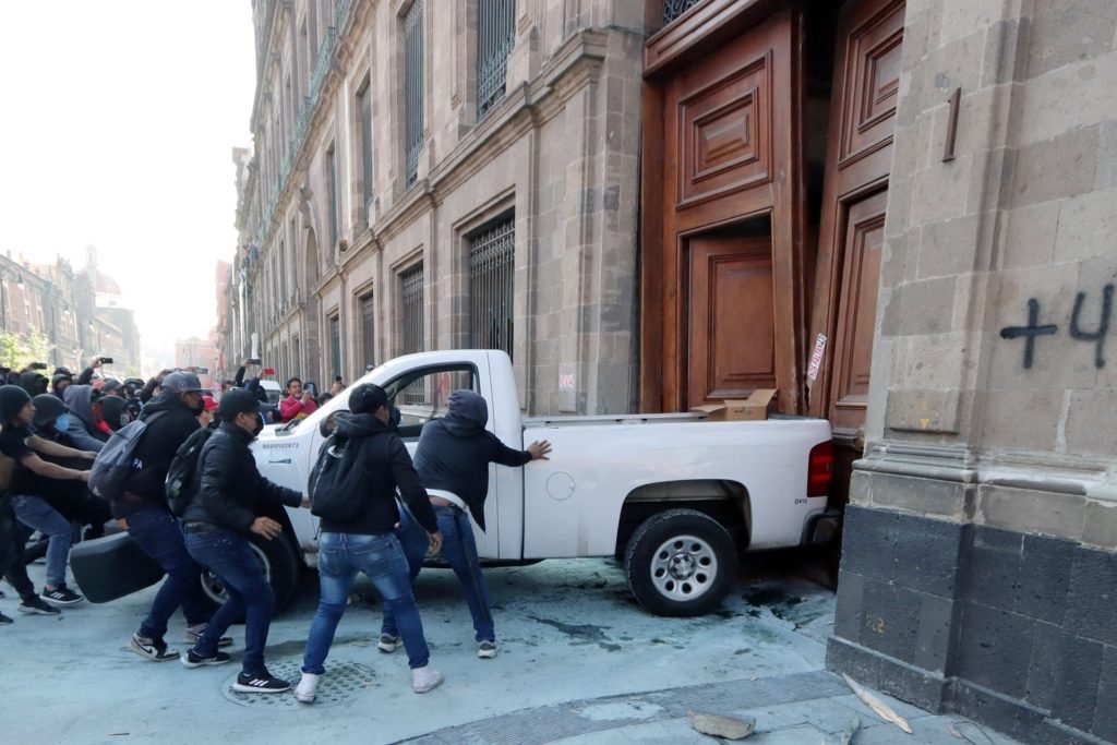 Protesting students use truck to ram down doors of Mexico City's National Palace - NBC News