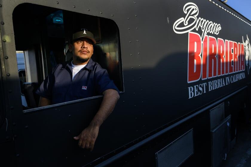 PARAMOUNT, CA - MARCH 20, 2024: Taco truck owner Bryan Tecun of Highland sits in the drivers seat of his truck where on March 10 he was stabbed while fighting with a thief who robbed a woman near his food truck on March 20, 2024 in Paramount, California. Tecun drove his taco truck down the street to block the thief and then jumped out to fight the man. He didn't realize he was stabbed until taken to the hospital in an ambulance.(Gina Ferazzi / Los Angeles Times)