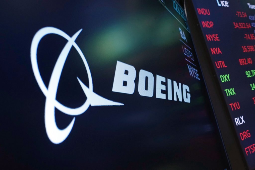 FILE - The logo for Boeing appears on a screen above a trading post on the floor of the New York Stock Exchange, July 13, 2021. Boeing reports earnings on Wednesday, April 26, 2023. (AP Photo/Richard Drew, file)