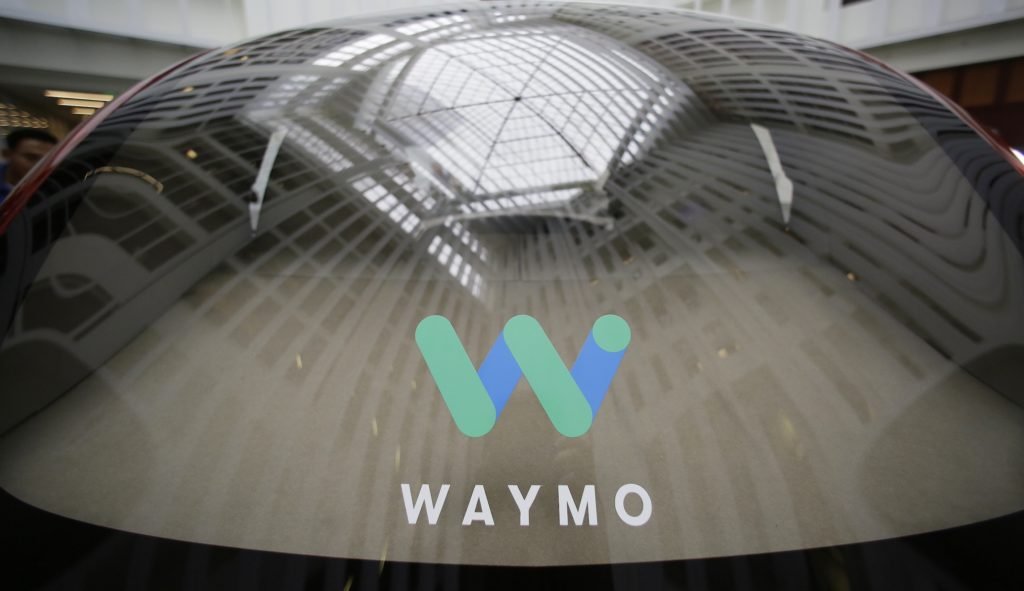 FILE - A skylight is reflected in the rear window of a Waymo driverless car during a Google event in San Francisco, Dec. 13, 2016. California regulators have authorized Waymo to expand services of its fleet of robotaxis into Los Angeles and to cities on the peninsula south of San Francisco. (AP Photo/Eric Risberg, File)