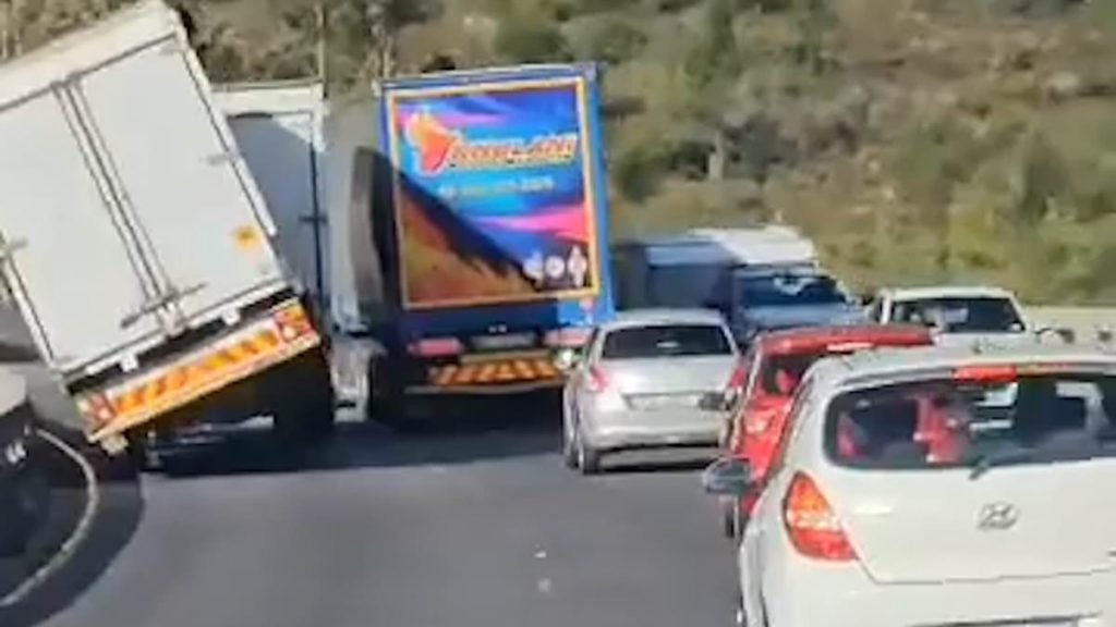 Terrifying moment truck and a caravan are blown off a bridge as storm winds hit South Africa - Daily Mail