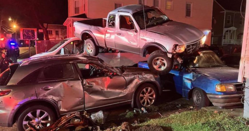 Pickup truck lands on top of cars in Brockton crash; driver flees scene - CBS Boston