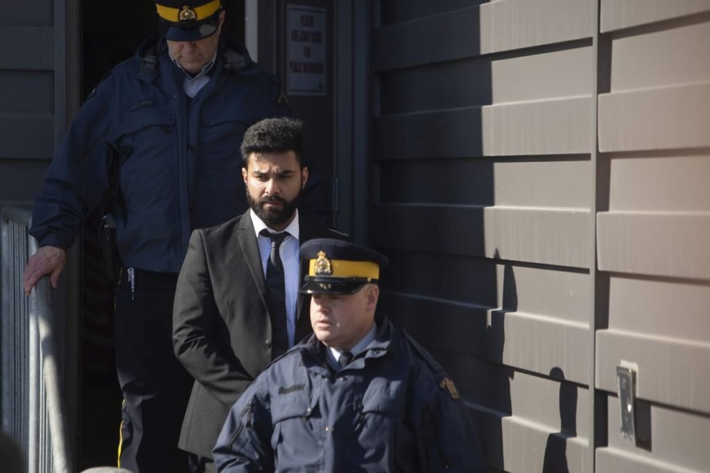 The trucker who caused the horrific Humboldt Broncos bus crash in 2018 will learn Friday whether he is to be deported. Jaskirat Singh Sidhu is taken out of the Kerry Vickar Centre by the RCMP following his sentencing for the Humboldt Broncos bus crash in Melfort, Sask., Friday, March 22, 2019. THE CANADIAN PRESS/Kayle Neis
