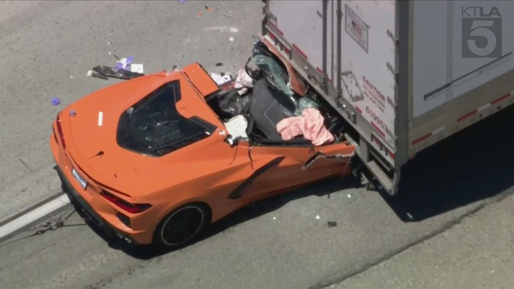 Driver hospitalized after sports car smashes into back of semi-truck - KTLA Los Angeles