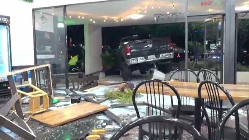 VIDEO: Truck slams into Florida bakery, crashes into parked car - WFLA